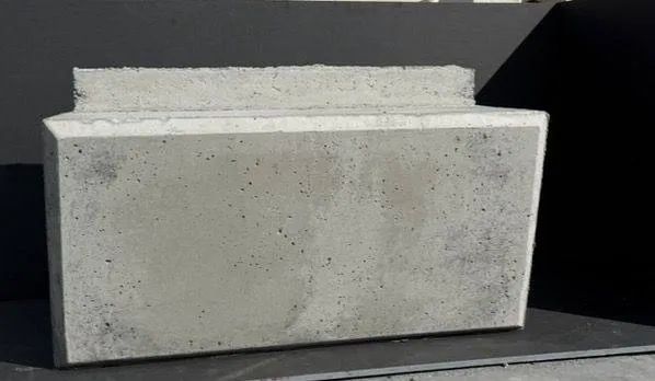 Heavy standard precast concrete block representative of a lay back wall unit